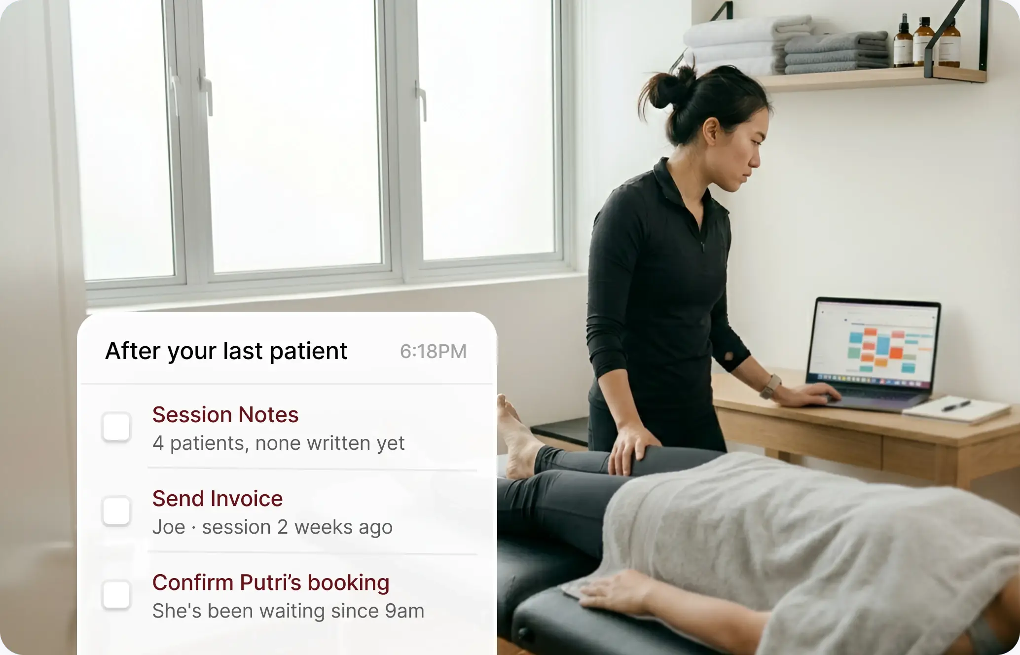 Physiotherapist working at a laptop next to a patient on the treatment table.